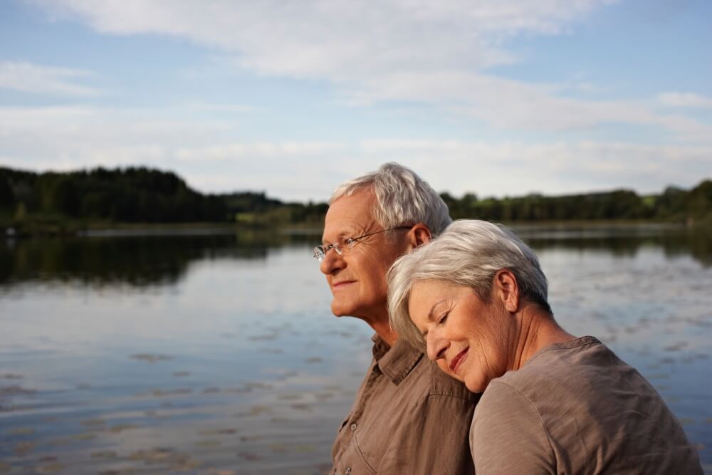 Title Senior couple hugging lake