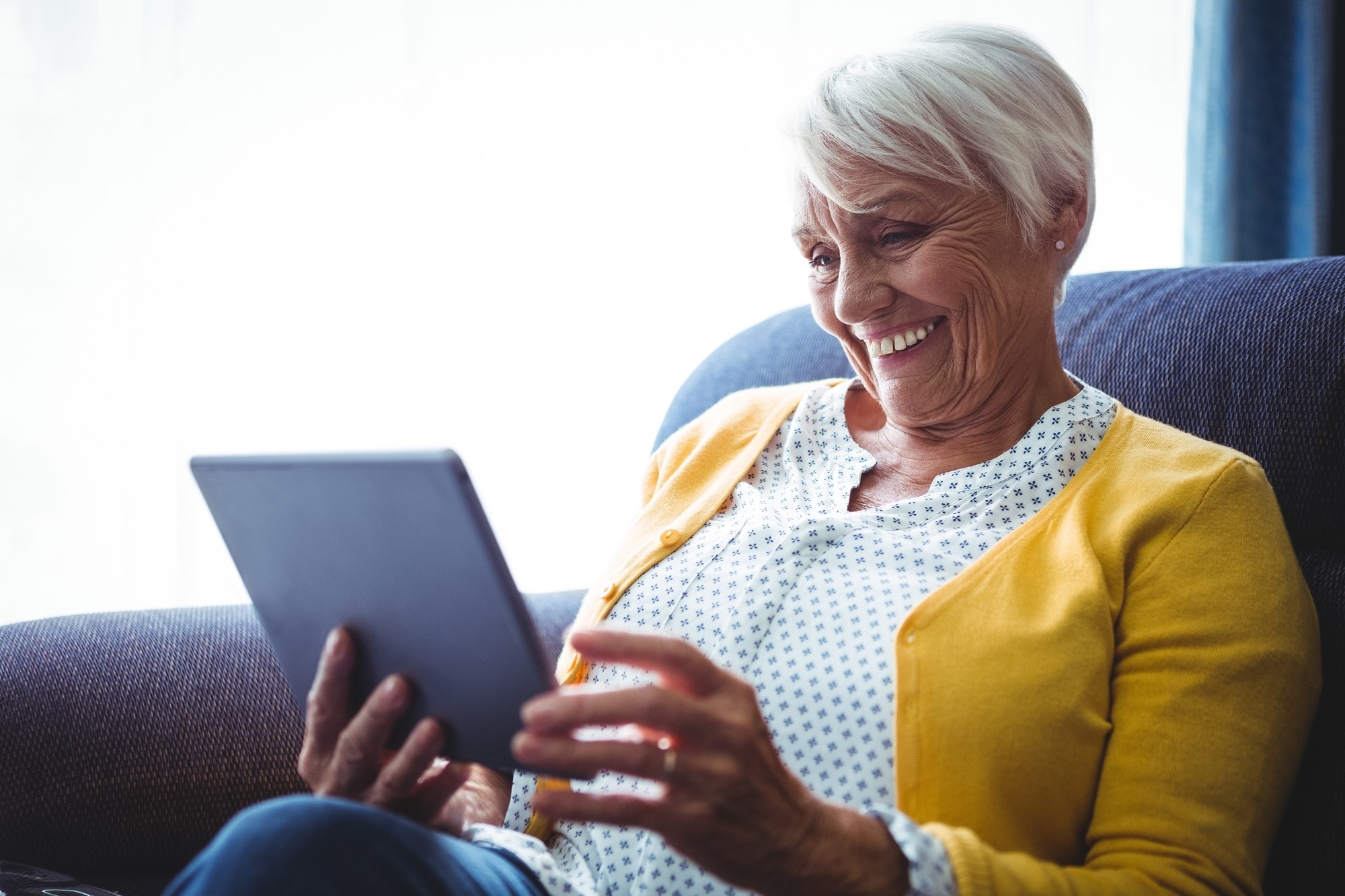Title Smiling_senior_woman_with_tablet
